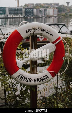 A brightly colored life preserver with the word 'Stocksholds' printed on the front in bold lettering Stock Photo