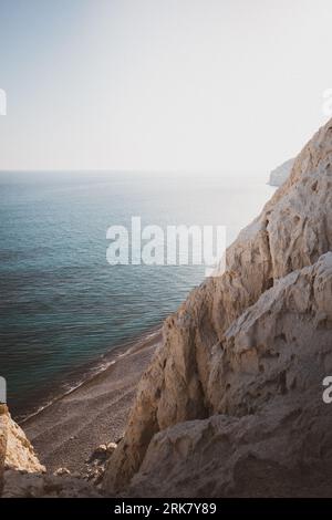 A beautiful shot of rocky cliffs over the water near Pissouri trail, Cape Aspro, Pissouri, Cyprus Stock Photo