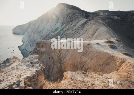 A beautiful shot of rocky cliffs over the water near Pissouri trail, Cape Aspro, Pissouri, Cyprus Stock Photo