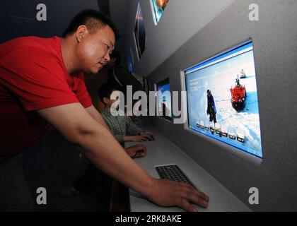 Bildnummer: 54006676  Datum: 01.05.2010  Copyright: imago/Xinhua (100501) -- SHANGHAI, May 1, 2010 (Xinhua) -- A visitor gets information about ship industry by computer at China Shipbuilding Industry Corporation Pavilion in the World Expo Park in Shanghai, east China, May 1, 2010. China Shipbuilding Industry Corporation Pavilion, the largest corporation pavilion of 2010 Shanghai World Expo located in Zone E, opened to the public on Saturday. The pavilion is reconstructed from an old factory and adds a new structure to the former plant. With the theme of Shipbuilding creates a better city life Stock Photo