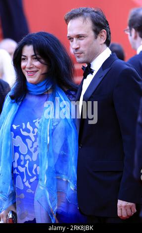 Bildnummer: 54044733  Datum: 12.05.2010  Copyright: imago/Xinhua (100513) -- CANNES, May 13, 2010 (Xinhua) -- French actor Vincent Perez(R) and Iranian writer Marjane Satrapi arrive for the opening ceremony and screening of Robin Hood presented out of competition at the 63rd Cannes Film Festival in Cannes, France, May 12, 2010. (Xinhua/Zhang Yuwei) (yc) (24)FRANCE-CANNES-FILM-FESTIVAL PUBLICATIONxNOTxINxCHN People Entertainment Film 63. Internationale Filmfestspiele Cannes kbdig xsk 2010 hoch     Bildnummer 54044733 Date 12 05 2010 Copyright Imago XINHUA  Cannes May 13 2010 XINHUA French Actor Stock Photo