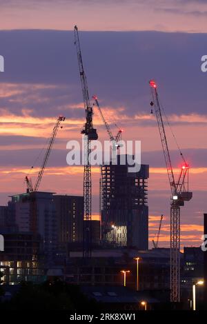 Sonnenaufgang im Stadtzentrum von Leeds mit Turmdrehkranen, die an verschiedenen Entwicklungen arbeiten Stockfoto