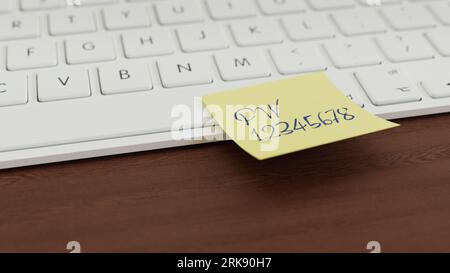 Informationssicherheitskonzept: Eine gelbe Notiz mit einem einfachen Passwort an einer Tastatur. Stockfoto