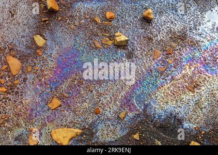 Farbenprächtiger Kraftstoff Und Öl Auf Asphalt, Der Eine Starke Umweltbelastung Zeigt Stockfoto