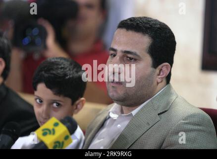 (100715) -- TEHRAN, July 15, 2010 (Xinhua) -- Iranian scholar Shahram Amiri (R) attends a press conference with his son after he arrived in Tehran, July 15, 2010. Shaharm Amiri, 32, who arrived in Tehran early in the morning, told a news conference that he was kidnapped by the CIA and the abduction was part of the U.S. campaign to add political pressures to Iran. (Xinhua/Ahmad Halabisaz) (gj) (7)IRAN-SCHOLAR-SHAHRAM AMIRI-RETURN PUBLICATIONxNOTxINxCHN Stock Photo