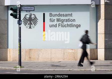 Berlin, Germany. 24th Aug, 2023. A man passes in front of the Federal Office for Migration and Refugees. Credit: Sebastian Gollnow/dpa/Alamy Live News Stock Photo