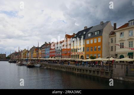 Denmark, Copenhagen - July 03, 2023: Nyhavn, the New Harbour, is lined by coloured townhouses, cafes and restaurants. Stock Photo