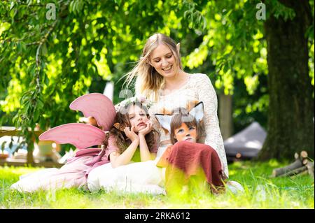 Ghent, East Flanders, Belgium - August 14, 2023 - Family shoot in the woods of cosplay mother and two young daughters Stock Photo