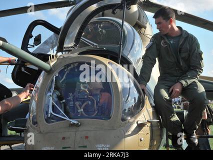 Bildnummer: 54282692  Datum: 07.08.2010  Copyright: imago/Xinhua (100808) -- KECSKEMET, Aug. 8, 2010 (Xinhua) -- A boy sits in the cockpit of a displayed MI-24 gunship on the opening day of the 11th International Air and Military Show in Kecskemet, Hungary, on August 7, 2010. The two-day event, organised by the Hungarian Ministry of Defence, is one of the biggest European air shows with 22 countries participating in programs including flying shows and displaying aircrafts. (Xinhua/Dani Dorko)(zl) HUNGARY-KECSKEMET-AIR -MILITARY-SHOW PUBLICATIONxNOTxINxCHN Gesellschaft kbdig xkg 2010 quer o0 Fl Stock Photo