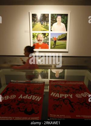 Bildnummer: 54432118  Datum: 14.09.2010  Copyright: imago/Xinhua BEIJING, Sept. 14, 2010 (Xinhua) -- A girl passes by an exhibited photo during a photography exhibition dubbed Happy @ 60--Looking at each other, a photographer exchange at 798 Art Zone in Beijing, capital of China, Sept. 14, 2010. The exhibition kicked off on Tuesday in the framework of the 60th anniversary of bilateral relations between Switzerland and China. Chinese photographer Zhu Yinghao and Swiss photographer Petri de Pita spent three weeks respectively in each other s country, taking photos of 60-year-old Chinese and Swis Stock Photo