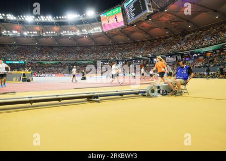 Volunteers removing marks and numbers during the 400 metres final during the world athletics championships 2023 at the National Athletics Centre, in Budapest, Hungary. (Sven Beyrich/SPP) Credit: SPP Sport Press Photo. /Alamy Live News Stock Photo