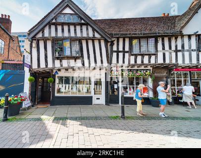 Worcester,Worcestershire,UK-August 21 2023:Tourists admire the crooked medieval 13th century,timbered buildings,along this atmospheric old street,save Stock Photo