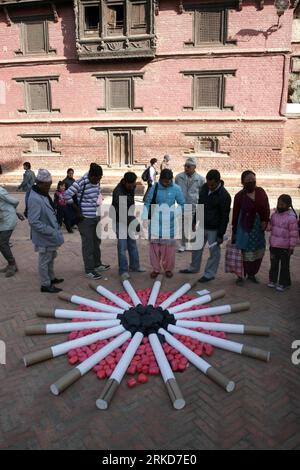 Bildnummer: 54881940  Datum: 04.02.2011  Copyright: imago/Xinhua (110204) -- KATHMANDU, Feb. 4, 2011 (Xinhua) -- Nepalese look at models of cigarettes set to promote citizens awareness of the relations between smoking and cancer during the commemoration of World Cancer Day at Patan Durbar Square, UNESCO World Heritage site, in Kathmandu, capital of Nepal, Feb. 4, 2011. Cancer is one of the leading causes of death around the world. WHO estimates that 84 million will die of cancer between 2005 and 2015. World Cancer Day is observed annually on 4th of February. (Xinhua/Bimal Gautam) (wjd) NEPAL-W Stock Photo