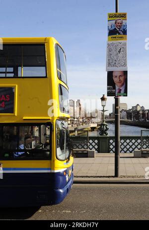 Bildnummer: 54950752  Datum: 24.02.2011  Copyright: imago/Xinhua DUBLIN, Feb. 24, 2011 (Xinhua) -- A bus runs past campaign posters of the Fine Gael party leader Enda Kenny (upper) and the Fianna Fail party leader Micheal Martin on a bridge in Dublin, Ireland, Feb. 24, 2011. Irish voters will go to polling stations to vote for a general election, with the opposition Fine Gael party leading the opinion polls. (Xinhua/Zeng Yi) IRELAND-DUBLIN-ELECTION PUBLICATIONxNOTxINxCHN Politik Irland Wahl Parlamentswahl Wahlkampf Plakat Wahlplakat kbdig xng 2011 hoch premiumd o0 Bus Linienbus    Bildnummer 5 Stock Photo