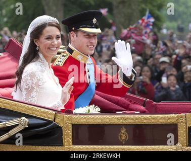 (110429) -- LONDON, April 29, 2011 (Xinhua) -- Britain s Prince William and his bride Kate Middleton wave on their way to Buckingham Palace after their wedding at Westminster Abbey in London, April, 29, 2011. (Xinhua/Tang Shi) (ybg) UK-LONDON-ROYAL WEDDING  - PRESS ASSOCIATION Photo. Photo credit should read: Kirsty Wigglesworth/PA Wire PUBLICATIONxNOTxINxCHN   110429 London April 29 2011 XINHUA Britain S Prince William and His Bride Kate Middleton Wave ON their Way to Buckingham Palace After their Wedding AT Westminster Abbey in London April 29 2011 XINHUA Tang Shi ybg UK London Royal Wedding Stock Photo