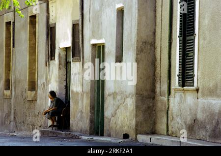 Nicosia Cyprus Old Town Elderly Woman Sitting on Front Porch of her House Stock Photo