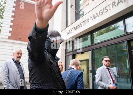 Metropolitan Police officer Thomas Phillips, covers his face, arrives at Westminster Magistrates' Court, London, for sentencing after he admitted five counts of sending grossly offensive messages using a public communication network, despite originally denying them. The WhatsApp messages were sent between April 8 and May 8, 2021. Picture date: Friday August 25, 2023. Stock Photo