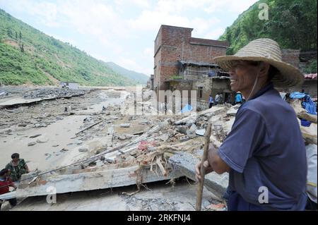 Bildnummer: 55442669  Datum: 09.06.2011  Copyright: imago/Xinhua (110609) -- WANGMO, June 9, 2011 (Xinhua) -- A man stands on the ruins near the river in Wangmo County of southwest China s Guizhou Province, June 9, 2011. China s Ministry of Finance (MOF) and Ministry of Civil Affairs on Wednesday allocated 35 million yuan (5.39 million U.S. dollars) to help victims of rain-triggered floods in Guizhou Province. Persistent downpours have wreaked havoc in Guizhou since June 3, forcing nearly 100,000 to evacuate. In the province s Wangmo County, floods have killed 21 and left more than 30 missing. Stock Photo