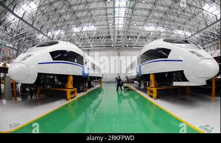 (110612) -- CHANGCHUN, June 12, 2011 (Xinhua) -- Two CRH380BL trains are seen at a plant of Changchun Railway Vehicles Co., Ltd. (CNR CRC) in Changchun, capital of northeast China s Jilin Province, June 11, 2011. The first EMU manufactured for Rio de Janeiro of Brazil was launched at CNR CRC on Tuesday. In late-June, twenty-two CRH380BL trains produced by CNR CRC will serve for the Beijing-Shanghai high speed railway. The CNR CRC is one of the leading railway vehicles manufacture enterprises in China. With advanced equipments and excellent research and development ability, the CNR CRC is able Stock Photo