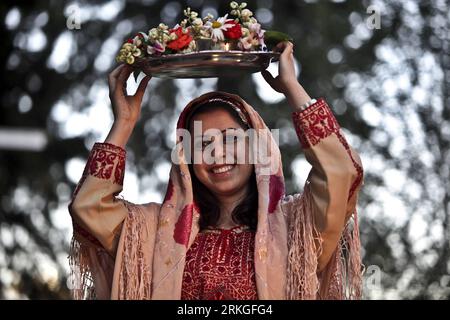 (110713) -- WEST BANK, July 13, 2011 (Xinhua) -- Bride Noor dances as she holds a plate of Henna during her traditional wedding ceremony in the West Bank town of Birzeit near Ramallah on July 13, 2011. The wedding was organized at the opening of the Birzeit cultural festival which aims to revive the Palestinian heritage. (Xinhua/Fadi Arouri) (wjd) MIDEAST-WEST BANK-TRADITIONAL WEDDING CEREMONY PUBLICATIONxNOTxINxCHN   110713 WEST Bank July 13 2011 XINHUA Bride Noor Dances As She holds a Plate of Henna during her Traditional Wedding Ceremony in The WEST Bank Town of Birzeit Near Ramallah ON Jul Stock Photo