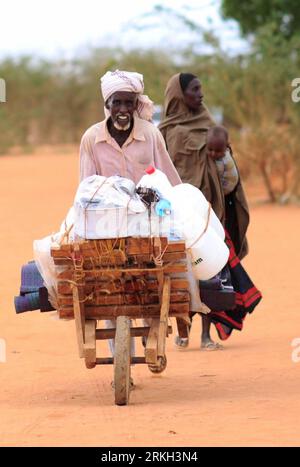 Bildnummer: 55681185  Datum: 05.08.2011  Copyright: imago/Xinhua (110806) -- DADAAB, Aug. 6, 2011 (Xinhua) -- Mohamed Ali, a 70-year-old Somali refugee, wheels the relief materials offered by the United Nations refugee agency UNHCR upon his arrival at the Dadaab refugee camp on the border of Kenya and Somalia, Aug. 5, 2011. The initial designed capacity of the Dadaab refugee camp, built in 1991, was 90,000. But some 400,000 refugees have stormed into it. And meanwhile, more than 1,300 refugees are arriving at the camp every day. (Xinhua/Zhao Yingquan) (lr) KENYA-SOMALIA-DADAAB-REFUGEES PUBLICA Stock Photo