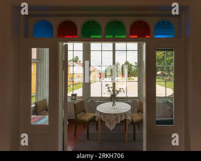 An elegant dining room with a large white table and chairs in the Granavolden Stock Photo