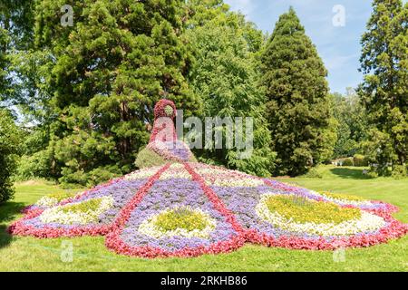 Mainau, Deutschland, 20. Juli 2023 die Figur eines Pfaus aus mit Blumen ist in einem schönen Park ausgestellt Stockfoto