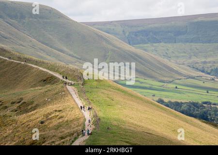 Family walkers and long-distance hikers take the footpath along the ridge between Mam Tor and Hollins Cross in the Peak District National Park, on 23rd August 2023, in Sheffield, England. Stock Photo