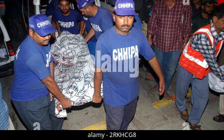 Toheed Police Rescuers carry an injured Pakistani police officer outside a police ...
