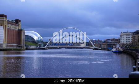 A picturesque view of the two bridges over the River Tyne, with a peaceful river in the foreground and a stunning cityscape in the background Stock Photo