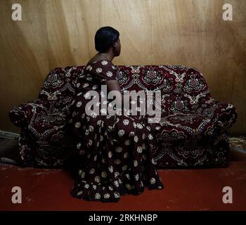 Bildnummer: 55879193  Datum: 22.08.2011  Copyright: imago/Xinhua (110901) -- YAOUNDE, Sep. 1, 2011 (Xinhua) -- Lady L sits in the sofa at her home in Yaounde, capital of Cameroon, Aug. 22, 2011. Thirty-four-year-old L was diagnosed with HIV in 2010. She has two children who live with their father in another city and she remains single while living with her younger brother. L lives on selling shoes, except for the cost of house rent and medicine fees, the 40,000 FCFA (91 dollars) monthly salary should also be paid for younger brother s living expenses. L hopes she can change a job to earn more Stock Photo