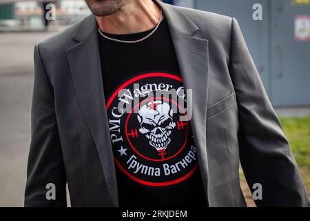 St. Petersburg, Russia. 24th Aug, 2023. A man wears a T-shirt with the symbol of the PMC Wagner military group at a spontaneous memorial dedicated to Yevgeny Prigozhin near the ''PMC Wagner Center'' in St. Petersburg in order to honor the memory of Yevgeny Prigozhin. On Wednesday, August 23, the Federal Air Transport Agency confirmed in a statement the death of 10 people who were on board a business jet belonging to businessman and founder of Wagner PMC Yevgeny Prigozhin, which crashed in the Tver region, Russia. The Federal Air Transport Agency also confirmed that Yevgeny Prigozhin was on th Stock Photo