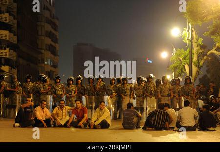 Bildnummer: 56146085  Datum: 04.10.2011  Copyright: imago/Xinhua (111005) -- CAIRO, Oct. 5, 2011 (Xinhua) -- Egyptian Coptic Christians attend a sit-in on the road as the police stand guard in front of the state TV building in downtown Cairo, Egypt, Oct. 4, 2011. Hundreds of Egyptian Christian Copts staged a sit-in on the road in front of the state TV building in downtown Cairo on Tuesday evening, demanding Aswan provincial governor el-Sayed step down and a church be rebuilt at Marinap village in Aswan province. (Xinhua/Qin Haishi) (wn) EGYPT-CAIRO-COPTIC CHRISTIANS-PROTEST PUBLICATIONxNOTxINx Stock Photo