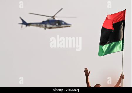 Bildnummer: 56209773  Datum: 23.10.2011  Copyright: imago/Xinhua (111023) -- BENGHAZI, Oct. 23, 2011 (Xinhua) -- A helicopter flies over the crowd as a man waves a Libyan National Transitional Council (NTC) flag during the celebration ceremony at the main Square in Benghazi, Libya, Oct. 23, 2011. The NTC Vice Chairman AbdelHafizGhoga Sunday declared here that Libya has been liberated from the regime of MuammarGaddafi. (Xinhua/Li Muzi) (wf) LIBYA-BENGHAZI-NATIONAL LIBERATION PUBLICATIONxNOTxINxCHN Gesellschaft Politik Libyen Befreiung xjh x1x premiumd 2011 quer     56209773 Date 23 10 2011 Copy Stock Photo