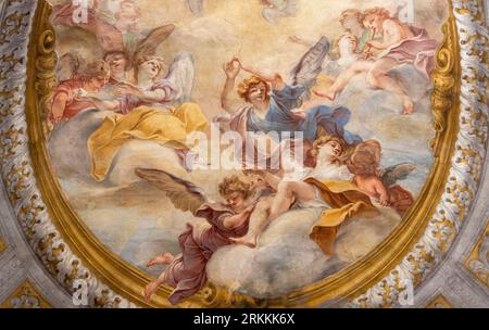 GENOVA, ITALY - MARCH 8, 2023:  The angels in the glory - fresco in the side chapel of church Chiesa di san Filippo Neri by  Marcantonio Franceschini Stock Photo