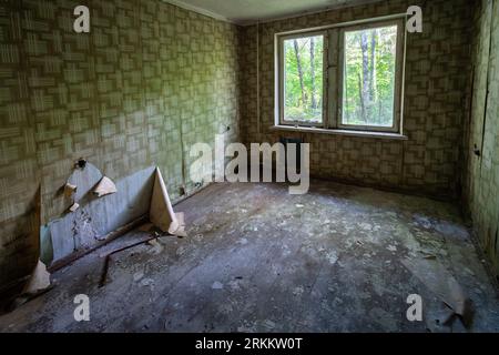 Interior of abandoned Room with wallpaper at Living Apartments of Duga Radar Village - Chernobyl Exclusion Zone, Ukraine Stock Photo