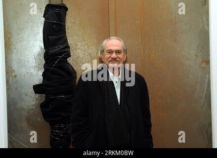 (111118) -- BEIJING, Nov. 18, 2011 (Xinhua) -- Jannis Kounellis stands in front of his work at Translating China -- Solo Exhibition of Jannis Kounellis in Beijing, capital of China, Nov. 18, 2011. The installation exhibition Translating China -- Solo Exhibition of Jannis Kounellis kicked off in Beijing on Friday. This exhibition witnesses the whole new works by Jannis Kounellis, the famous Arte Povera master from Italy. Artists of Arte Povera often use junks and everyday materials as the media of their artworks. (Xinhua/Jin Liangkuai) (zgp) CHINA-BEIJING-JANNIS KOUNELLIS-EXHIBITION (CN) PUBLIC Stock Photo