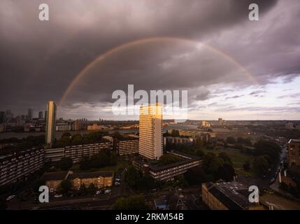 London, UK. 25th August, 2023. UK Weather: A massive rainbow breaks at sunset over east London during a brief rainstorm. Credit: Guy Corbishley/Alamy Live News Stock Photo