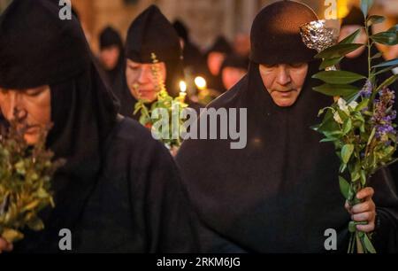 Jerusalem, Israel. 25. August 2023. Eine Gruppe griechisch-orthodoxer Nonnen (russische Nonnen), die Kerzen, Basilikum und Blumen in der Prozession der Ikone der Dormition der Theotokos nach Gethsemane halten. Quelle: Yoram Biberman/Alamy Live News. Stockfoto