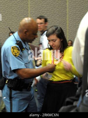 Bildnummer: 56675507  Datum: 09.12.2011  Copyright: imago/Xinhua (111209) -- DURBAN (SOUTH AFRICA), Dec. 9, 2011 (Xinhua) -- Abigail Borah, a New Jersey resident, is stopped by a policeman when delivering a speech at the closing plenary of the Durban climate change negotiations in Durban, South Africa, on Dec. 8, 2011. After nearly two weeks of stalled progress at the United Nations climate change conference in South Africa, the young American attracted high attention by calling for a real, science-based climate treaty on Thursday. Abigail Borah delivered the speech calling for an urgent path Stock Photo