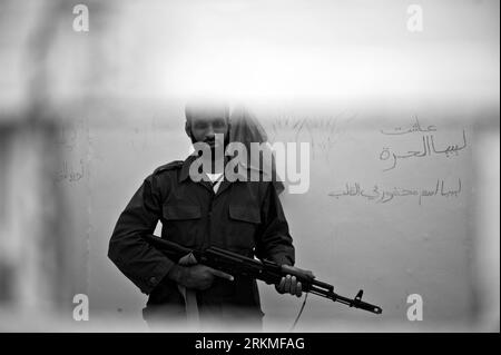 Bildnummer: 56696700  Datum: 06.10.2011  Copyright: imago/Xinhua  Yusuf Abedalwahed Alsaiede, 31, holds a AK-103 assault rifle at the cell he used to live at Abu Salim Prison, Tripoli, Libya, Oct. 6, 2011. Yusuf spent more than four months at this prison before he was released in Aug. 2011. Like Yusuf, three to five prisoners used to share a cell about ten square-meters in this prison. Abu Salim, where the Abu Salim prison is located, has been a symbolic area for     s supporters. In 2011 September, over 1,270 bodies of prisoners were discovered by the NTC in the area. They were considered to Stock Photo