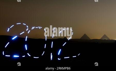 Bildnummer: 56792292  Datum: 29.12.2011  Copyright: imago/Xinhua (111229) -- CAIRO, Dec. 29, 2011 (Xinhua) -- The light painting photo taken on Dec. 26, 2011 in front of the pyramids in Cairo, Egypt, shows the sign of 2012 , to greet the coming New Year. (Xinhua/Qin Haishi) (msq) EGYPT-CAIRO-LIGHT PAINTING-2012 PUBLICATIONxNOTxINxCHN Gesellschaft Fotomontage Silvester Neujahr Jahreswechsel xda x0x 2011 quer      56792292 Date 29 12 2011 Copyright Imago XINHUA  Cairo DEC 29 2011 XINHUA The Light Painting Photo Taken ON DEC 26 2011 in Front of The Pyramids in Cairo Egypt Shows The Sign of 2012 t Stock Photo