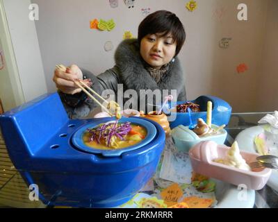 Bildnummer: 56802797  Datum: 02.01.2012  Copyright: imago/Xinhua (120103) -- BEIJING, Jan. 3, 2012 (Xinhua) -- A woman takes a meal at a toilet-themed restaurant in Beijing, capital of China, on Jan. 2, 2012. The restaurant is decorated as a washroom, where closestool-shaped containers are used. (Xinhua) (wqc) CHINA-BEIJING-TOILET-THEMED RESTAURANT(CN) PUBLICATIONxNOTxINxCHN Gesellschaft Wirtschaft Gastronomie Restaurant Toilette Kurios Komik premiumd xbs x0x 2012 quer      56802797 Date 02 01 2012 Copyright Imago XINHUA  Beijing Jan 3 2012 XINHUA a Woman Takes a Meal AT a Toilet themed Restau Stock Photo