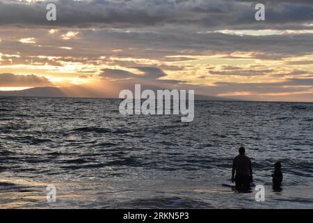 Maui. 21st Aug, 2023. Photo taken on Aug. 21, 2023 shows people swimming in the sea in Maui, Hawaii, the United States. The devastating wildfires that ravaged the Hawaiian island of Maui were a bitter blow to the island's tourism industry, but local residents and business leaders expect more tourists will come back as the island embarks on a long road ahead for recovery. Credit: Zeng Hui/Xinhua/Alamy Live News Stock Photo