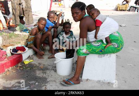 Bildnummer: 57240563  Datum: 06.03.2012  Copyright: imago/Xinhua (120306) -- BRAZZAVILLE, March 6, 2012 (Xinhua) -- A woman washes clothes as her baby sleeping on her back at a church which is taken for refuge in Brazzaville, capital of the Republic of Congo, March 6, 2012. The church has accepted some 2,000 refugees who became homeless because of the March 4 blasts, lacking of food and water. (Xinhua/Han Bing) REPUBLIC OF CONGO-BRAZZAVILLE-BLAST-REFUGEE PUBLICATIONxNOTxINxCHN Gesellschaft Explosion Waffenlager Munitionsdepot Notunterkunft Obdachlose xjh x0x 2012 quer      57240563 Date 06 03 Stock Photo