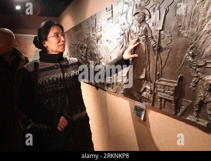 Bildnummer: 57266463  Datum: 07.03.2012  Copyright: imago/Xinhua (120307) -- BEIJING, March 7, 2012 (Xinhua) -- Photo taken on Feb. 27, 2012 shows Yang Jia, a blind professor of the Chinese Academy of Sciences and a member of the 11th National Committee of the Chinese People s Political Consultative Conference (CPPCC), touching a carving in an exhibition hall of the China Braille Publishing House in Beijing, capital of China. Yang, who lost her eyesight at the age of 29, devoted herself to the pursuit of rights of with disabilities. (Xinhua/Wang Jianhua) (llp) (TWO SESSIONS)CHINA-BEIJING-CPPCC Stock Photo