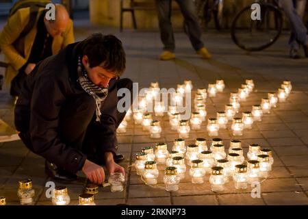 Bildnummer: 57368625  Datum: 11.03.2012  Copyright: imago/Xinhua (120312) -- BUDAPEST, March 12, 2012 (Xinhua) -- A man lights candles to form a radiation symbol in Budapest, March 11, 2012, during a ceremony marking the first anniversary of the Fukushima nuclear disaster. A devastating earthquake and tsunami hit northeastern Japan on March 11, 2011, left more than 19,000 dead or missing and triggered a nuclear accident the world had never seen since 1986. (Xinhua/Attila Volgyi)(ctt) HUNGARY-BUDAPEST-FUKUSHIMA-REMEMBERING PUBLICATIONxNOTxINxCHN Gesellschaft Gedenken Trauer Jahrestag Katastroph Stock Photo