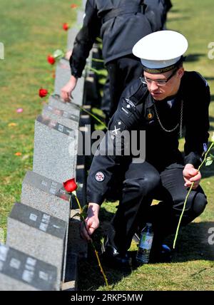 Bildnummer: 57898056  Datum: 15.04.2012  Copyright: imago/Xinhua (120415) -- HALIFAX, April 15, 2012 (Xinhua) -- A soldier places a flower in front of a tomb during the commemoration at the Fairview Lawn Cemetery in Halifax, Canada, April 15, 2012. Halifax, a port city located on the eastern coast of Canada, has an intricate connection between the unsinkable Titanic. The initial search and rescue efforts for survivors were launched from Halifax. Today, there are 150 Titanic victims rested at the Fairview Lawn, Mount Olivet and Baron de Hirch cemeteries in Halifax. (Xinhua/Wang Lei) CANADA-HALI Stock Photo