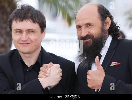 (120519) -- CANNES, May 19, 2012 (Xinhua) -- Romanian actor Valeriu Andriuta and director Cristian Mungiu (L) pose during a photocall for Romanian film Dupa Dealuri (Beyond the Hills) at the 65th Cannes Film Festival in Cannes, southern France, May 19, 2012. Dupa Dealuri will compete with other 21 feature films for 2012 Golden Palm (Palme d Or), the most prestigious award of the 65th Cannes International Film Festival. (Xinhua/Gao Jing) (dzl) FRANCE-CANNES-FILM FESTIVAL-PHOTOCALL-DUPA DEALURI PUBLICATIONxNOTxINxCHN Stock Photo