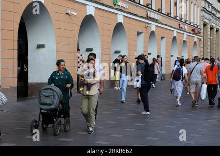 Saint Petersburg, Russia. 25th Aug, 2023. A family of foreigners, tourists with a small child walks along Nevsky Prospekt near the Stockmann department store in the very center of Saint Petersburg. Credit: SOPA Images Limited/Alamy Live News Stock Photo